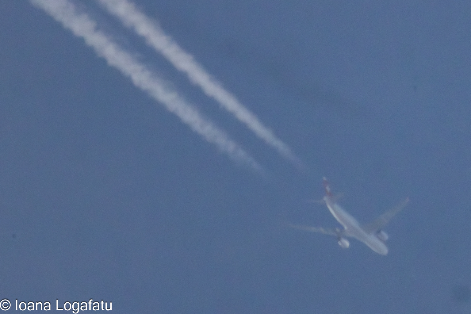 High-flying aircraft creating contrails in the sky